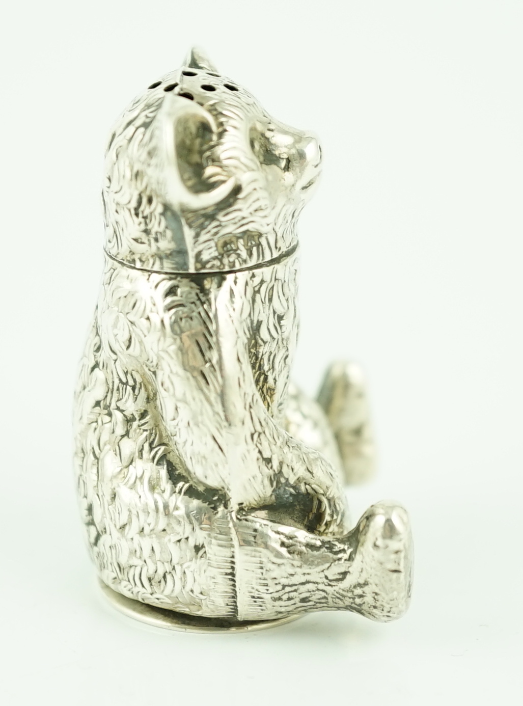 An Edwardian novelty silver pepperette modelled as a seated bear, Crisford & Norris
